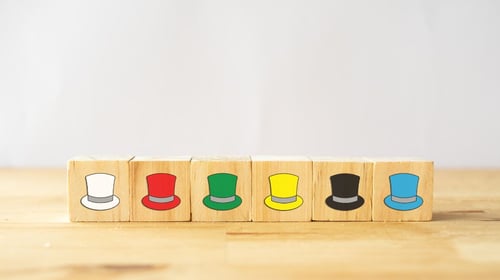 Wooden blocks with images of hats on them. 6 Thinking Hats method.