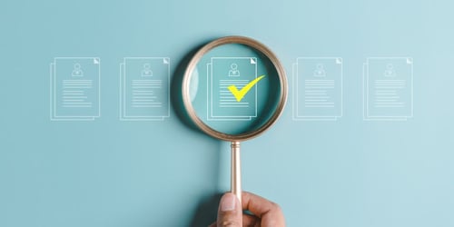 A magnifying glass held over a paper. Blogpost about identifying the right ideas to. invest in as a company.