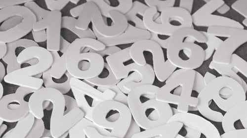 Numbers scrambled over a surface. Blogpost about Innovation Accounting.