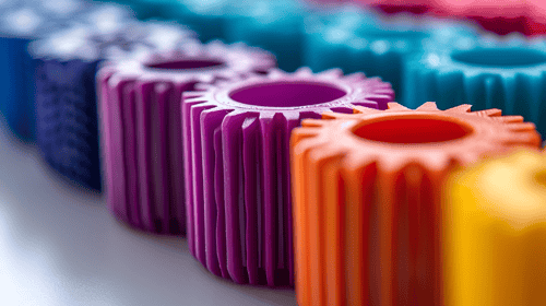 Colorful gears or cogwheels on a White Background, Featuring Dark Yellow Orange, and Pink Tones. Blogpost about shifting gears in innovation.