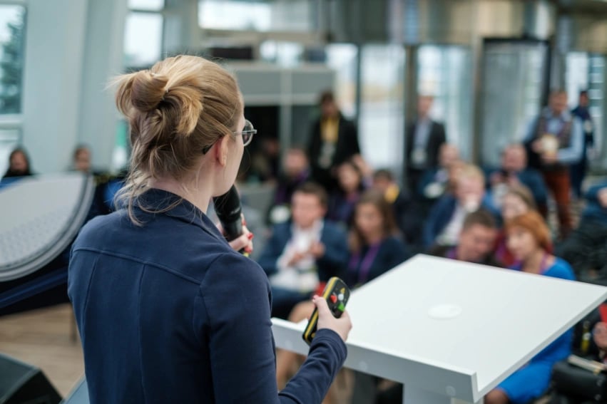 Person making a speech in front of audience