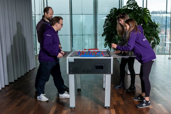 people playing table football in office