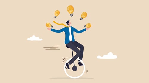 Businessman riding unicycle juggling lightbulb.