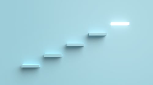 Steps on a blue background leading up to a final step that has a bright light shining from it. Blogpost about corporate innovation best-practices.