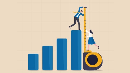  A man and woman use a giant tape measure representing how to measure innovation.